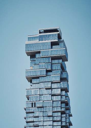 high rise blue high-rise building under a calm blue sky urban